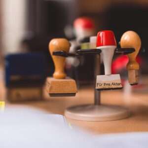 A variety of rubber stamps in selective focus on a wooden table indoors.
