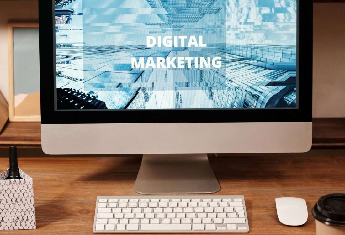 Contemporary office setup featuring digital marketing strategy on a computer screen, ideal for business technology themes.